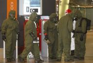 Hazmat crews gather at the main hall of Kuala Lumpur International Airport 2 in Sepang, Malaysia on Sunday, Feb. 26, 2017. Malaysian police order a sweep of Kuala Lumpur airport for toxic chemicals and other hazardous substances following the killing of Kim Jong Nam. (AP Photo/Daniel Chan)