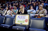 A sign reading "Kobe Rest In Peace" is displayed on an empty seat in the first half of a basketball game between the Phoenix Suns and the Memphis Grizzlies, Sunday, Jan. 26, 2020, in Memphis, Tenn. Former NBA player Kobe Bryant died in a California helicopter crash Sunday. (AP Photo/Brandon Dill)