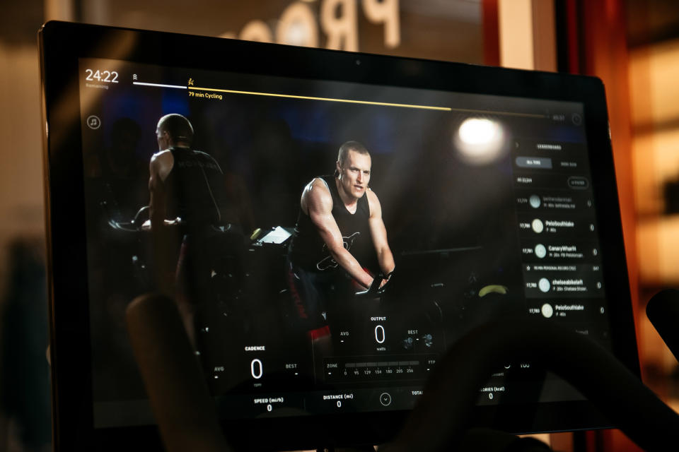 NEW YORK, NY - DECEMBER 04: An instructor is seen on the video display of a Peloton stationary bike at the fitness company's studio on Manhattan's 23rd Street on December 4, 2019 in New York City. Peloton and its model of on-demand video cycling classes has come under fire after the release of a new commercial that has been criticized by some as sexist and classist. (Photo by Scott Heins/Getty Images)