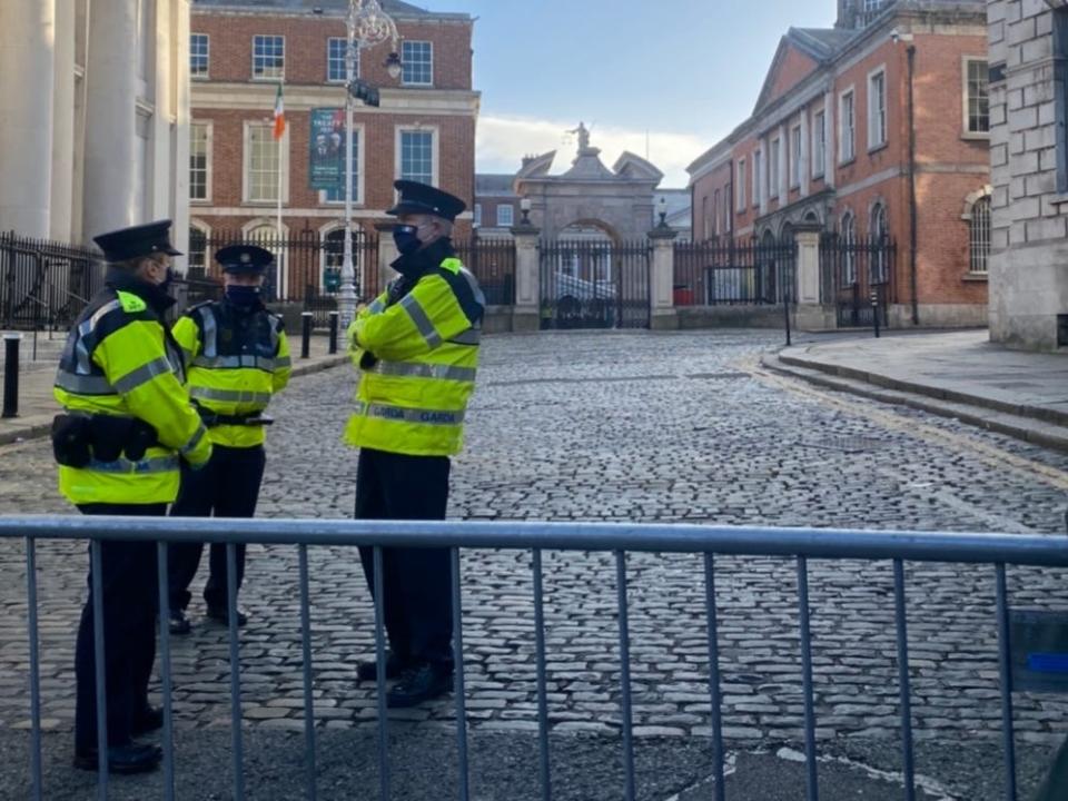 police officers huddled on a cobblestone street in dublin