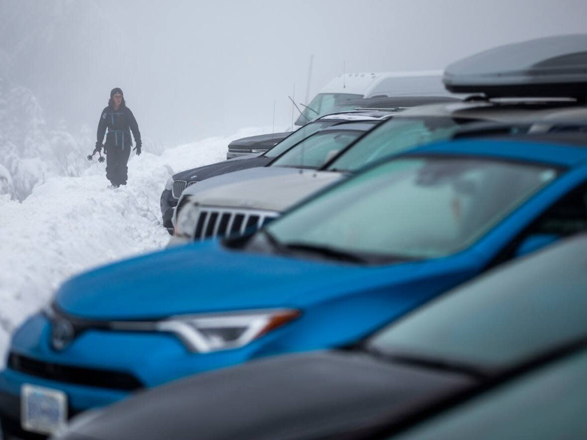 A woman looks for her car at Mount Seymour Provincial Park near North Vancouver, B.C., on Dec. 27, 2019. For the second year, visitors to the park who do not have a valid ski pass will need to apply for a free vehicle day-use pass. (Ben Nelms/CBC - image credit)