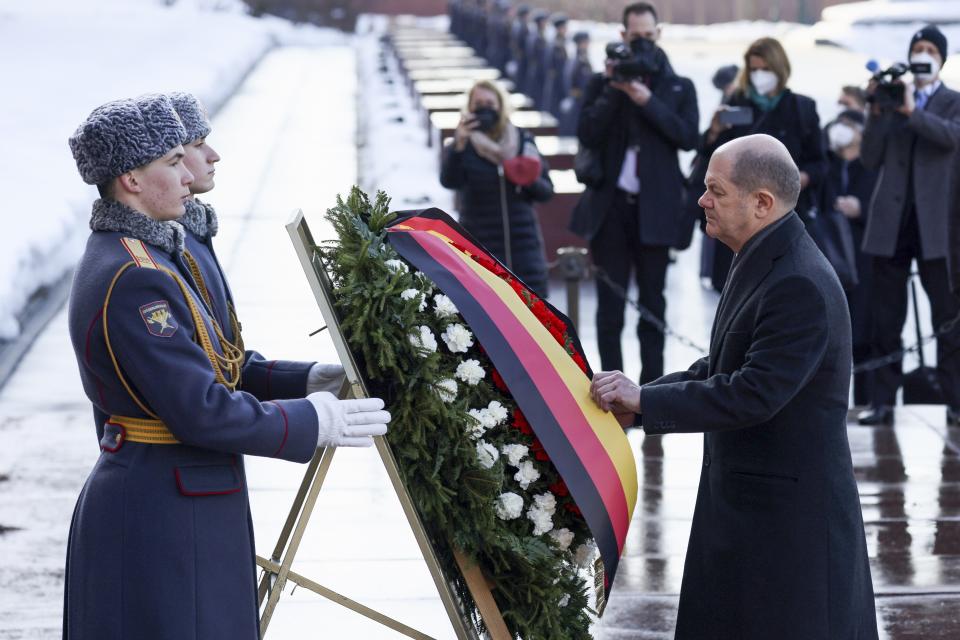 German Chancellor Olaf Scholz attends a wreath-laying ceremony at the Tomb of the Unknown Soldier at the Kremlin Wall in Moscow, Russia, Tuesday, Feb. 15, 2022. (Maxim Shemetov/Pool Photo via AP)