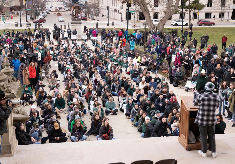 Protesters hold signs to protest gun violence at a student sit-in at the Michigan Capitol building following a mass shooting at Michigan State University earlier in the week in Lansing, Mich., on Wednesday, Feb. 15, 2023.