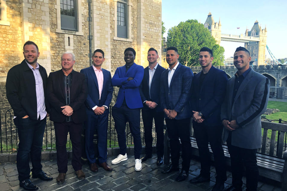 From left, New York Yankees catcher Austin Romine, batting practice pitcher Danilo Valiente, coach Carlos Mendoza, shortstop Didi Gregorius, pitcher Zack Britton, catcher Gary Sanchez, pitcher Luis Cessna and shortstop Gleyber Torres pose outside the Tower of London, Friday, June 28, 2019. At rear right is the Tower Bridge. The Yankees and Boston Red Sox are playing two baseball games in London this weekend. (AP Photo/Ron Blum)