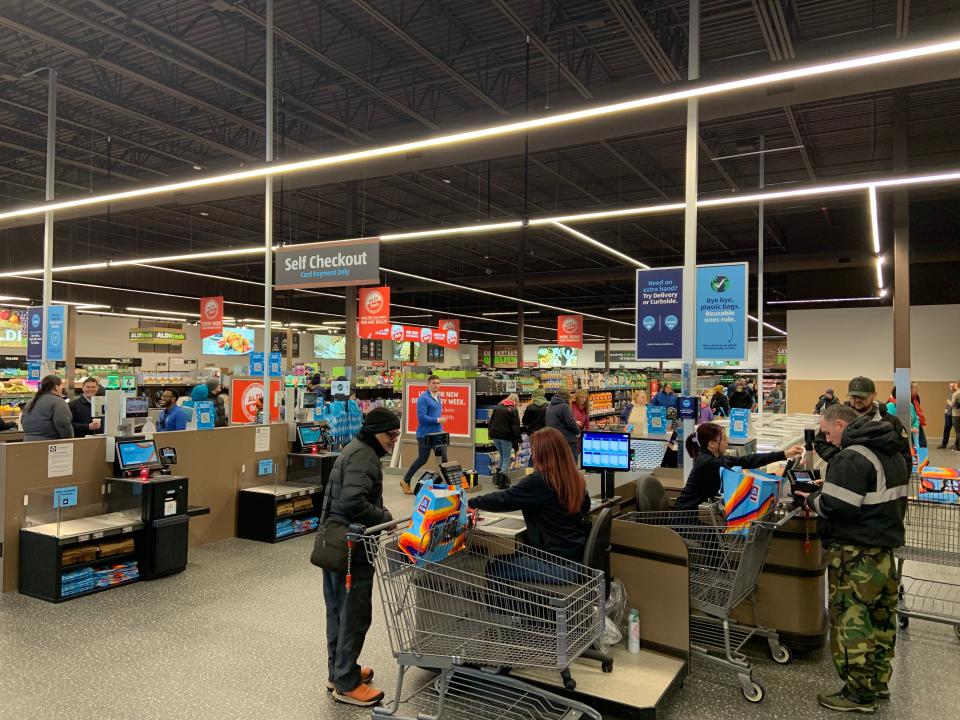 The first customers check out after being the first to shop at the new Aldi location at Timpany Plaza in Gardner on Thursday.