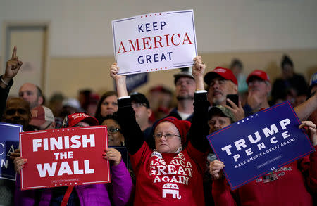 Supporters wave signs before U.S. President Donald Trump arrives to speak at a Make America Great Again rally in Richmond, Kentucky, U.S., October 13, 2018. REUTERS/Joshua Roberts