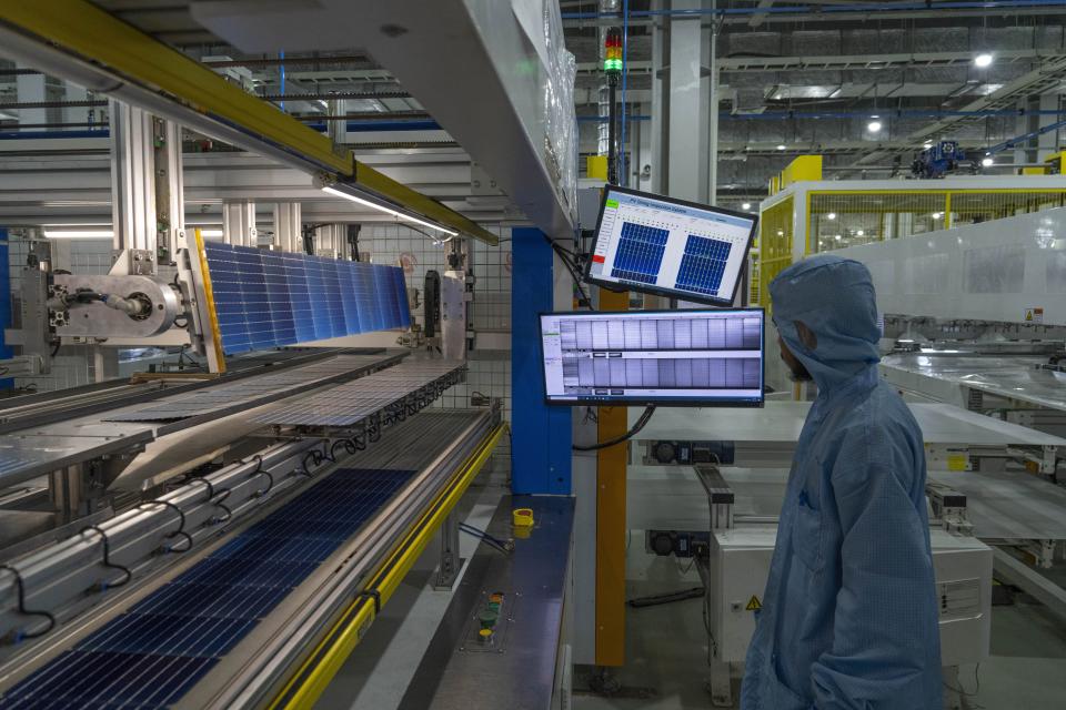 Machine operators work on cell printing for solar panels at the Adani-owned Mundra Solar Techno-Park Private Limited, in the port town of Mundra in Western India's Gujarat state, India, Wednesday, Sept. 20, 2023. It's one of the few locations in India where most solar energy components are made from scratch. (AP Photo/Rafiq Maqbool)