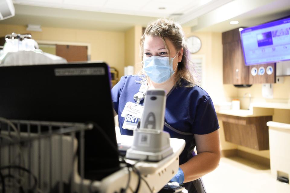  Ashley Branson, a respiratory therapist at the University of Tennessee Medical Center, checks on a patient Wednesday, Nov. 17, 2021.