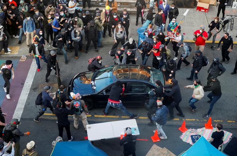 Protesters were seen trying to pull the driver out of the vehicle near Capitol Hill. Source: Reuters