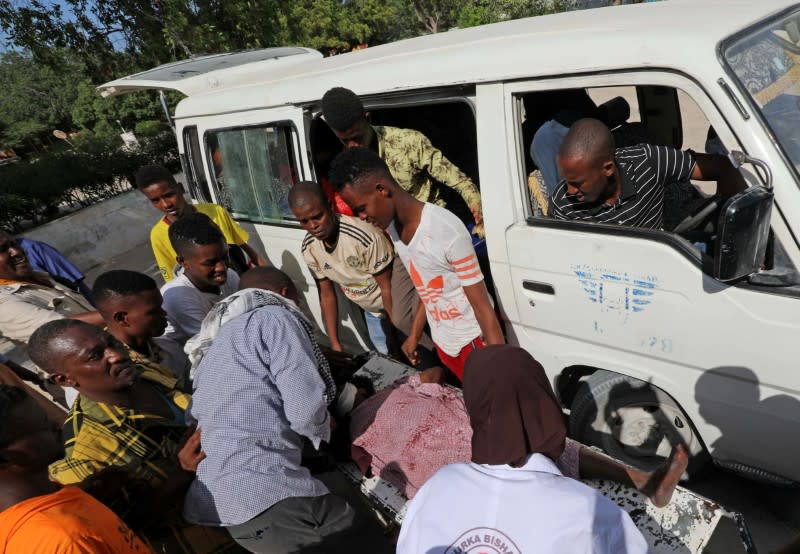 Paramedics and civilians at Madina hospital assist an injured man after a minibus struck a roadside bomb at Hawa Abdi village, northwest of Mogadishu