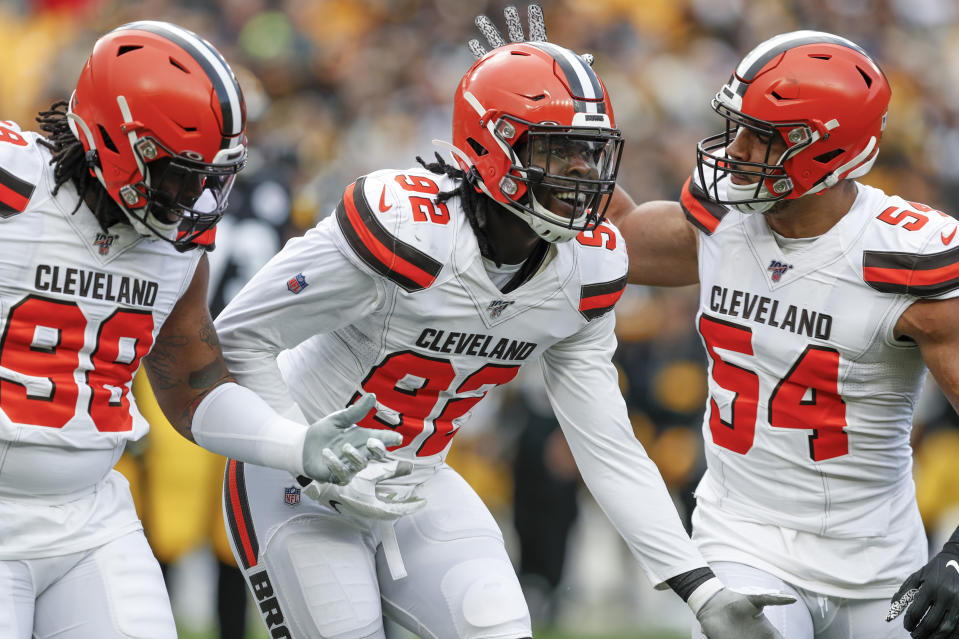 Cleveland Browns defensive end Chad Thomas (92) celebrates with defensive end Olivier Vernon (54) and defensive tackle Sheldon Richardson (98) after sacking Pittsburgh Steelers quarterback Devlin Hodges in the first half of an NFL football game, Sunday, Dec. 1, 2019, in Pittsburgh. (AP Photo/Don Wright)