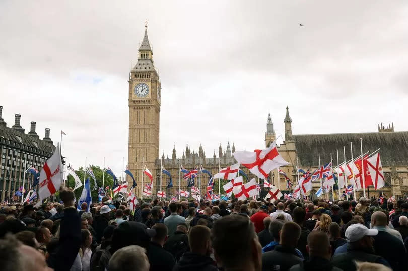People take part in a protest march at Parliament Square in London, organised by Tommy Robinson, whose real name is Stephen Yaxley Lennon