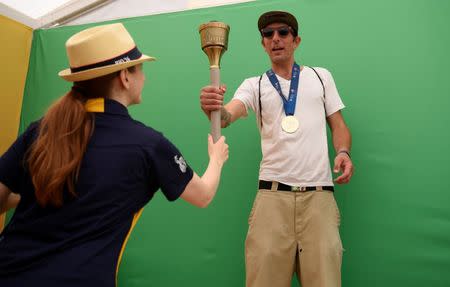 Jul 23, 2016; Los Angeles, CA, USA; Terri Freedman (left) hands a prop to Berdj Sulahian (right) during the Team USA Road to Rio tour at Venice Beach. Mandatory Credit: Kelvin Kuo-USA TODAY Sports