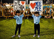 Two girls, who are nieces of East Coast GRC candidate Glenda Han, hold up signs in support of their aunt as she makes her speech. (Yahoo! photo/ Terence Lee)