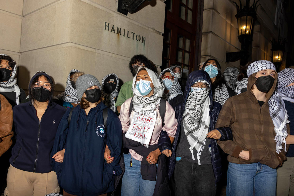 Students and demonstrators lock arms to guard potential authorities against reaching fellow protestors who barricaded themselves inside Hamilton Hall t Columbia University in New York City (Alex Kent / Getty Images file )