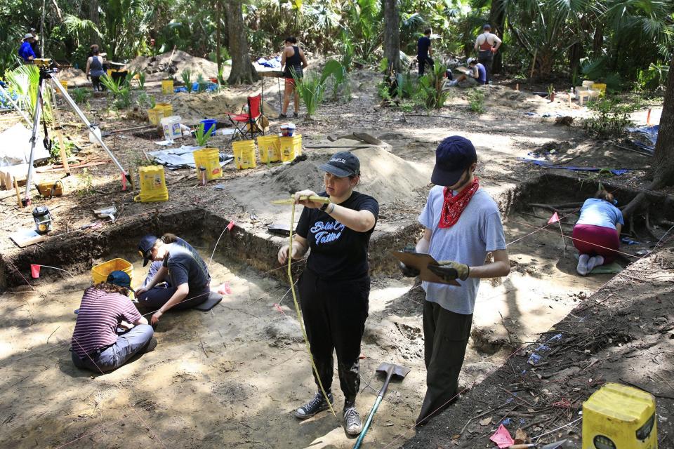 University of North Florida senior and field assistant Annie Bitner, center, and senior Ben Szaroleta map an area during Wednesday's excavation for an archaeology class at the possible site of a 16th-century Mocama village of Sarabay.