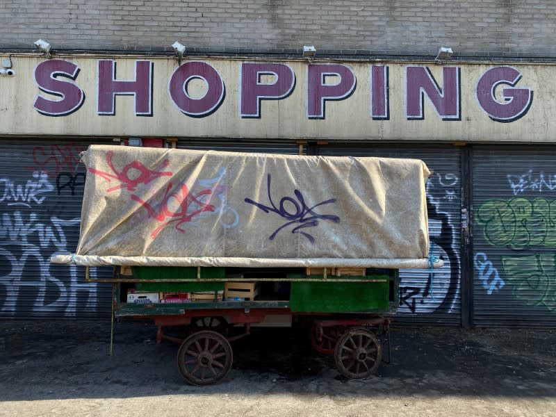 FILE PHOTO: An old barrow covered in tarpaulin is seen at Ridley Road Market in Hackney