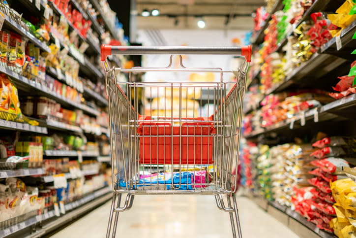 A cart in a grocery store aisle