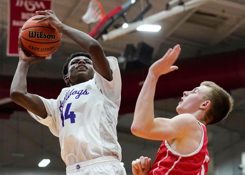 Brownsburg Bulldogs forward Kanon Catchings (14) reaches for a lay-up on Saturday, March 11, 2023 at Southport High School in Indianapolis. The Brownsburg Bulldogs defeated the New Palestine Dragons, 66-39, for the IHSAA Class 4A regional championship. 