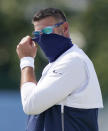 FILE - In this Aug. 18, 2020, file photo, Tennessee Titans head coach Mike Vrabel adjusts his mask during NFL football training camp in Nashville, Tenn. On Sunday, Oct. 25, Steelers-Titans will be the eighth time in league history undefeated and untied teams with at least five wins have met in the regular season, the sixth such game since the 1970 merger, and only the fifth in the past 46 seasons. (AP Photo/Mark Humphrey, Pool, File)