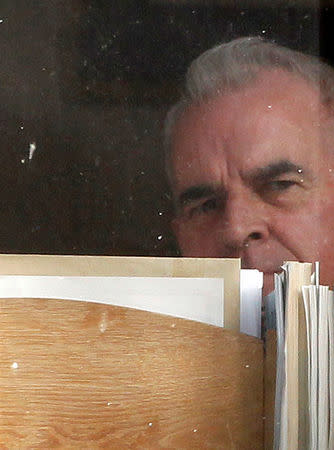 FILE PHOTO: Cardinal Keith O'Brien looks out of a window from a room in his home in Edinburgh, Scotland, Britain February 26, 2013. REUTERS/David Moir/File Photo