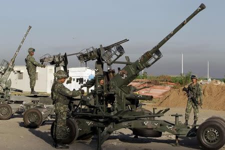 Philippine marines man their anti-aircraft gun emplacement near the venues of the Asia-Pacific Economic Cooperation (APEC) summit, during the first day of the APEC CEO summit, in Manila November 16, 2015. REUTERS/Janis Alano