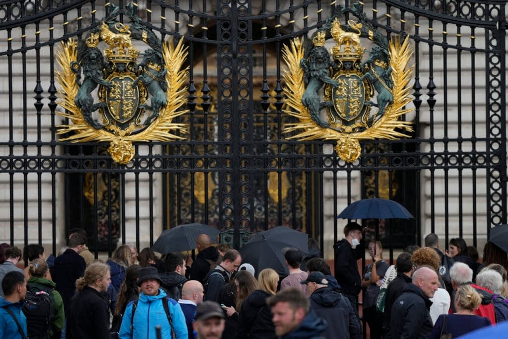 People gather outside Buckingham Palace in London, Thursday, Sept. 8, 2022. Buckingham Palace says Queen Elizabeth II has been placed under medical supervision because doctors are “concerned for Her Majesty’s health.” Members of the royal family traveled to Scotland to be with the 96-year-old monarch. (AP Photo/Frank Augstein)