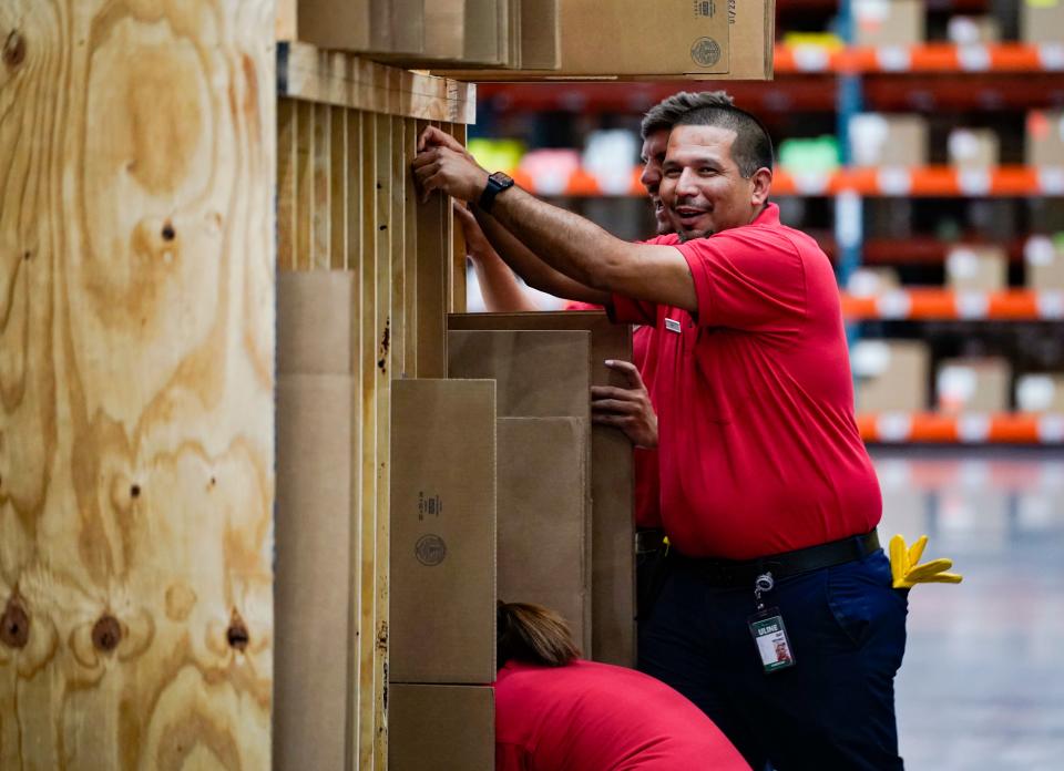 Employees sort through boxes for packing at the Uline warehouse in Naples on Tuesday, April 18, 2023.