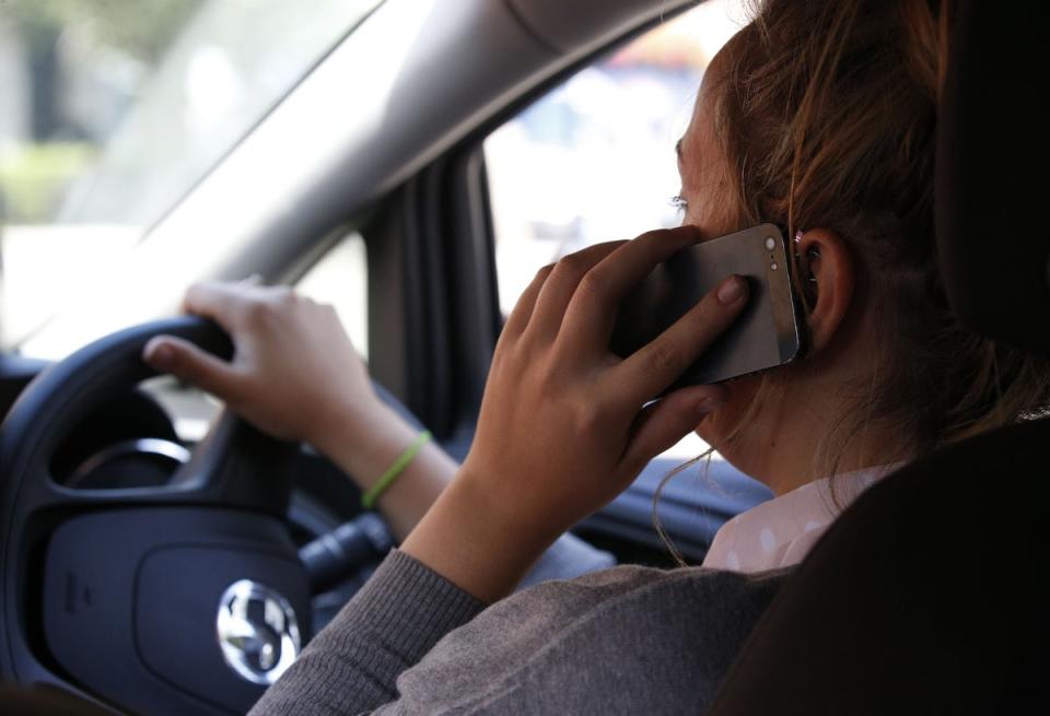 Motorists can be handed six penalty points and a £200 fine for holding a phone while they are behind the wheel (Jonathan Brady/PA) (PA Wire)