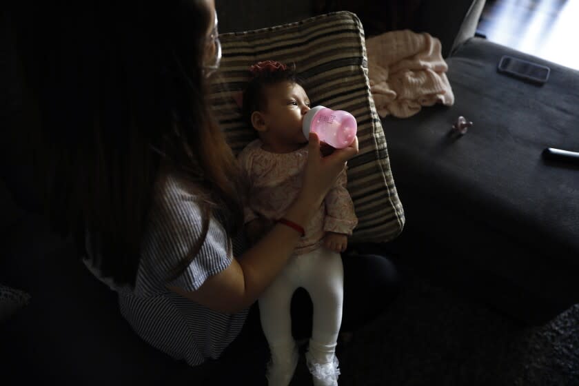 WILMINGTON-CA-MAY 6, 2022: Veronica Gutierrez, 26, feeds her three month old daughter Alessandra at home in Wilmington on Friday, May 6, 2022. (Christina House / Los Angeles Times)