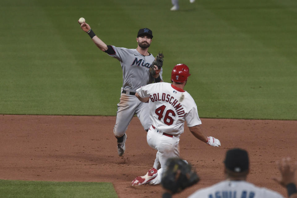 St. Louis Cardinals first baseman Paul Goldschmidt (46) is out at second as Miami Marlins second baseman Jon Berti, top, throws out St. Louis Cardinals' Nolan Arenado during the fifth inning of a baseball game Monday, June 14, 2021, in St. Louis. (AP Photo/Joe Puetz)