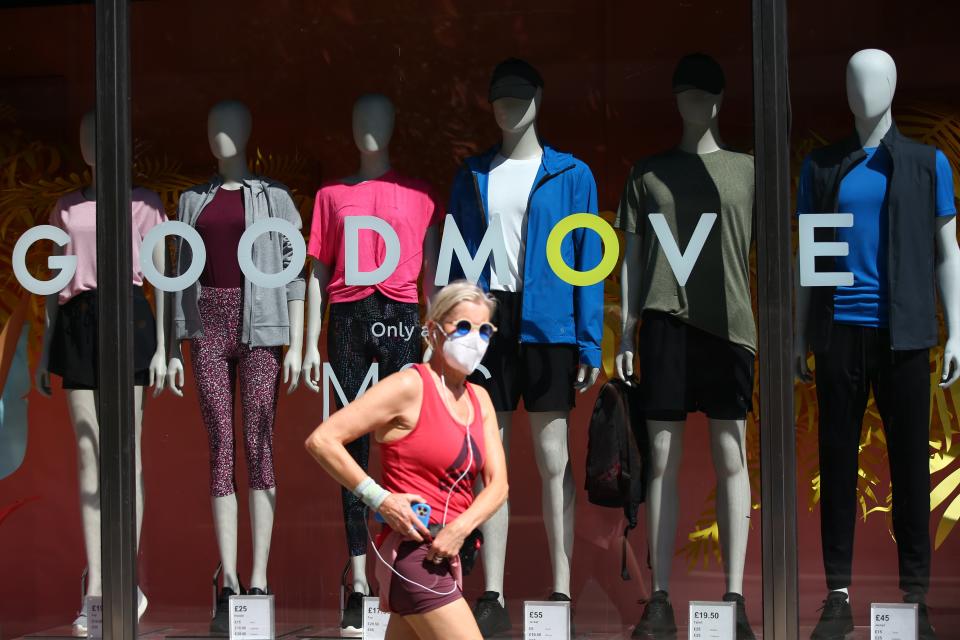 A pedestrian wearing a face covering walks past a shop on Oxford Street  (Getty Images)