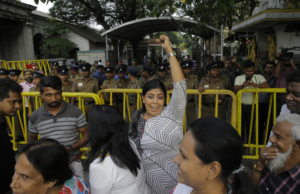 Supporters of ousted Sri Lankan Prime Minister Ranil Wickremesinghe celebrate outside the supreme court complex in Colombo, Sri Lanka, Thursday, Dec. 13, 2018. Sri Lanka's Supreme Court unanimously ruled as unconstitutional President Maithripala Sirisena's order to dissolve Parliament and call for fresh elections, a much-anticipated verdict Thursday that further embroils the Indian Ocean island nation in political crisis.(AP Photo/Eranga Jayawardena)