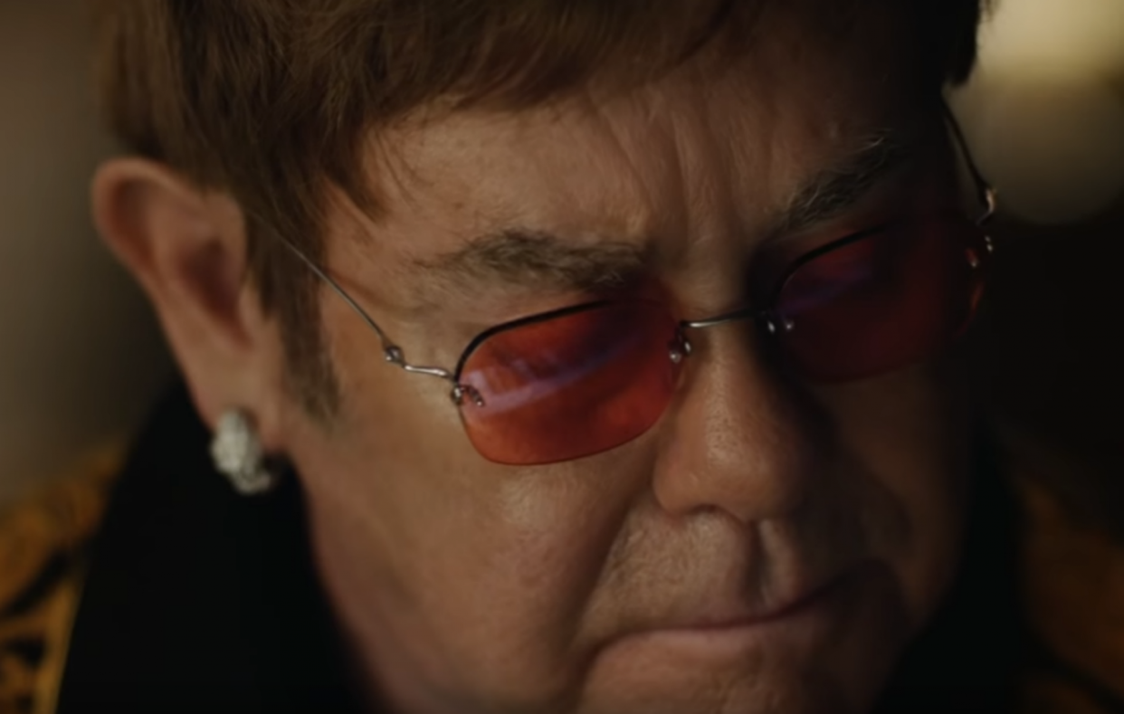 Elton John looks back reflectively in department store Elton John’s new holiday ad. (Photo: YouTube)