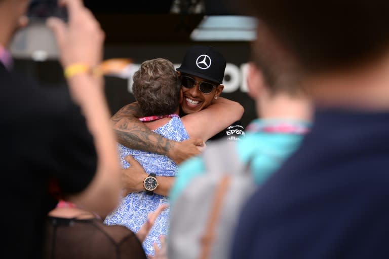 Mercedes AMG Petronas F1 Team's British driver Lewis Hamilton (R) hugs his mother after winning the British Formula One Grand Prix at the Silverstone circuit on July 5, 2015