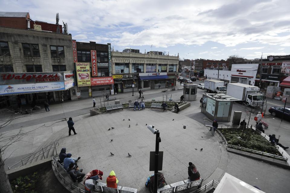 Pedestrians walk Corona Plaza in Queens, NYC on April 2, 2020. Data released by city health officials show that residents in Jackson Heights, Elmhurst and Corona sections of Queens -- largely working class, immigrant neighborhoods -- have tested positive for the coronavirus at higher rates than in wealthy, mostly white parts of Manhattan and Brooklyn.  (Photo: ASSOCIATED PRESS)