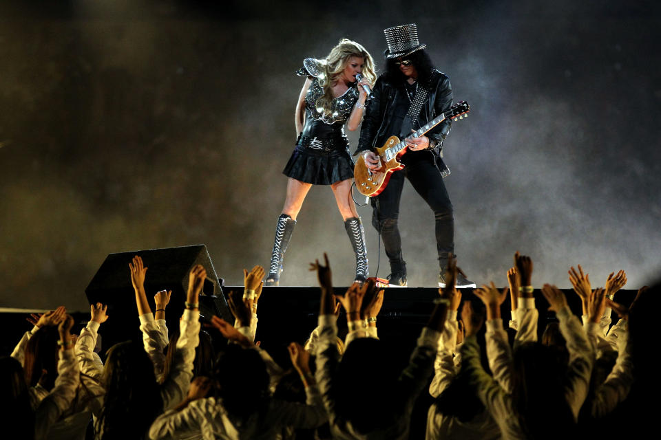 Fergie of the Black Eyed Peas performs with Slash during the Bridgestone Super Bowl XLV Halftime Show at Cowboys Stadium on February 6, 2011 in Arlington, Texas. (Photo by Al Bello/Getty Images)