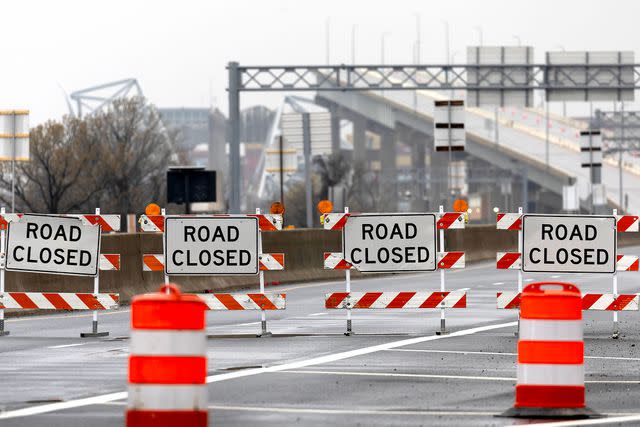 <p>Scott Olson/Getty</p> Signs in front of bridge collapse