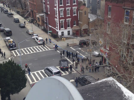 Police block off the scene of a shooting where a gunman killed two New York police officers as they sat in their squad car before killing himself in New York, in this December 20, 2014 handout photo courtesy of Mariana Pena Cater. REUTERS/Mariana Pena Cater/Handout via Reuters