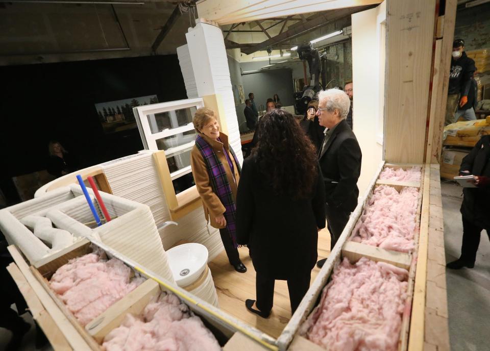 MADCO3D founding partner Dan Bernard displays a module of a home for Sen. Jeanne Shaheen, left, and Isabel Casillas Guzman, administrator of the U.S. Small Business Administration at the Rochester 3D printing company Friday, Dec. 8, 2023.