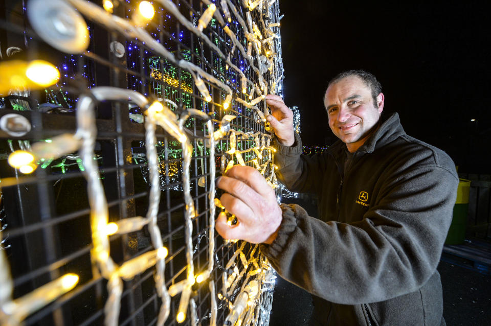 <em>The tractor was made using 11,000 sparkling lights and two miles of wiring (Picture: SWNS)</em>