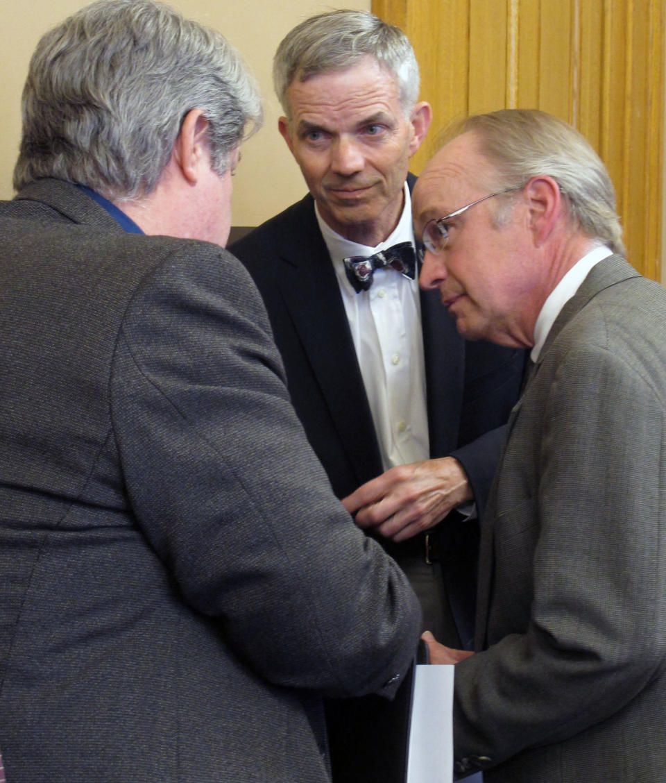Richard Cram, center, policy and research director for the Kansas Department of Revenue, confers with Steve Stotts, left, the department's taxation director, and Gordon Self, right, an attorney on the Legislature's bill-drafting staff, during negotiations between the House and Senate over tax cuts, Thursday, April 26, 2012 at the Statehouse, in Topeka, Kan. (AP Photo/John Hanna)