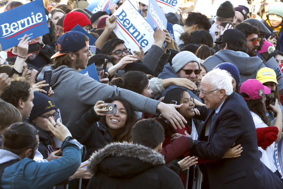 Democratic presidential candidate Sen. Bernie Sanders, I-Vt., is hugged as he works the crowd after a campaign rally in Chicago's Grant Park Saturday, March 7, 2020. (AP Photo/Charles Rex Arbogast)