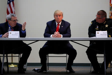 Republican U.S. presidential nominee Donald Trump, flanked by St. Johns County Sheriff David Shoar (L) and Brevard County Sheriff Wayne Ivey (R), meets with law enforcement and first responders at the St. Johns County Sheriff's Department in St. Augustine, Florida, U.S. October 24, 2016. REUTERS/Jonathan Ernst