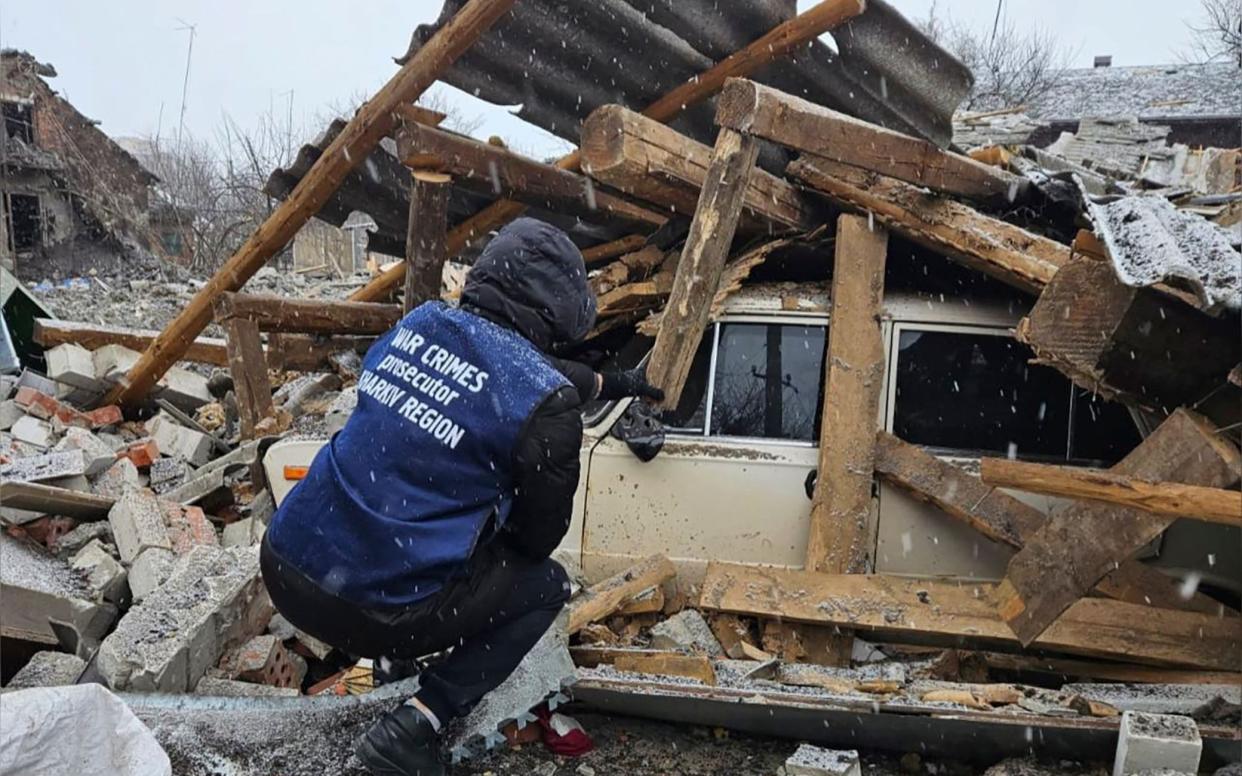 A car buried by rubble after Russian strikes on Ukraine's Kharkiv region