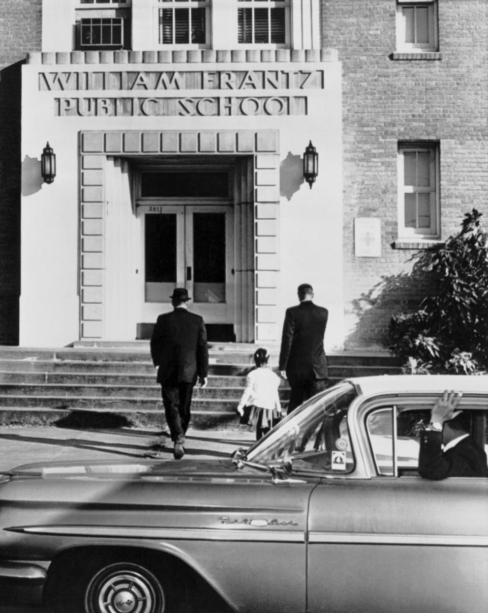 <span class="caption">U.S. Marshals escort Ruby Bridges to the William Frantz Elementary School in New Orleans on Nov. 28, 1960.</span> <span class="attribution"><a class="link " href="https://www.gettyimages.com/detail/news-photo/ruby-bridges-is-escorted-by-us-federal-marshals-into-news-photo/507247753?adppopup=true" rel="nofollow noopener" target="_blank" data-ylk="slk:Underwood Archives/Getty Images;elm:context_link;itc:0;sec:content-canvas">Underwood Archives/Getty Images</a></span>