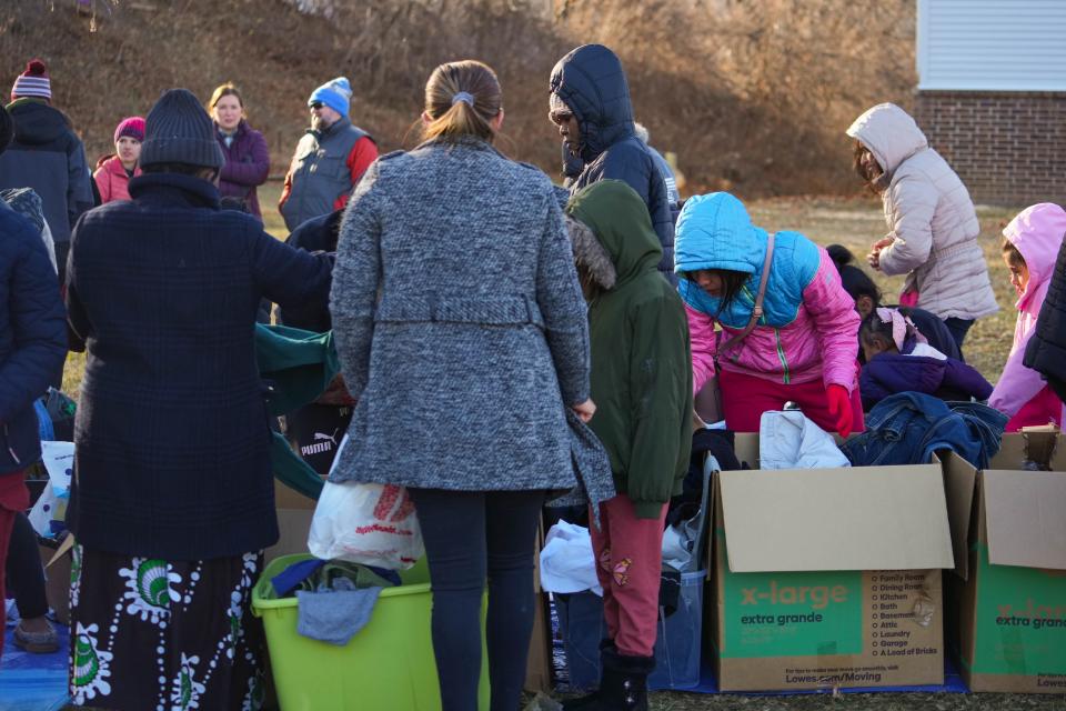 Families pick out clothes at the Hickman Flats in Des Moines on Saturday.