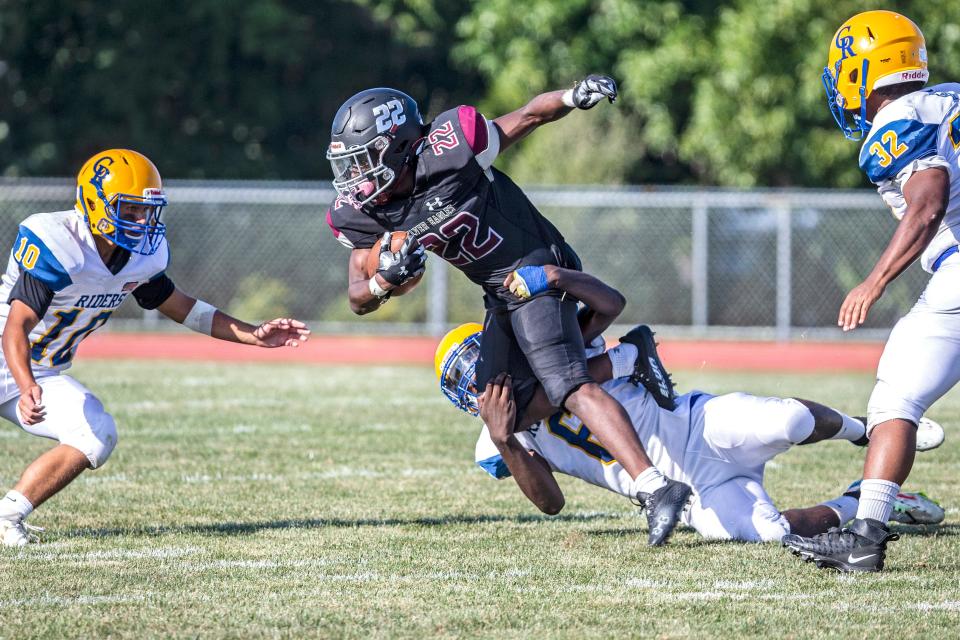 Hodgson Vo-Tech Silver Eagles running back Maki Beach (22) is tackled by Caesar Rodney Riders defensive end Kevin Takazala (6) during the Hodgson vs. Caesar Rodney high school football game at Hodgson in Glasgow, Thursday, Sept. 1, 2022. Hodgson won 31-0.