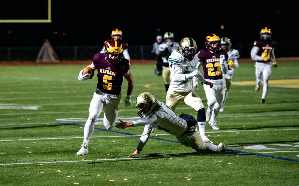 Windsor senior running back Chase Thomas (5) slips a tackle en route to a punt return for a touchdown during a playoff game against Bear Creek at H.L. Dudley Field on Friday.