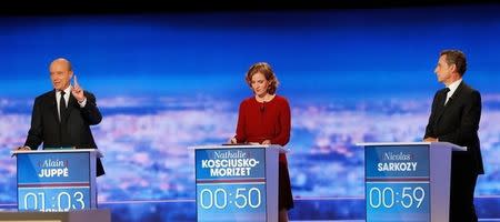 French politician Alain Juppe (L) speaks as Nathalie Kosciusko-Morizet (C) and Nicolas Sarkozy listen during the first prime-time televised debate for the French conservative presidential primary in La Plaine Saint-Denis, near Paris, France, October 13, 2016. REUTERS/Philippe Wojazer